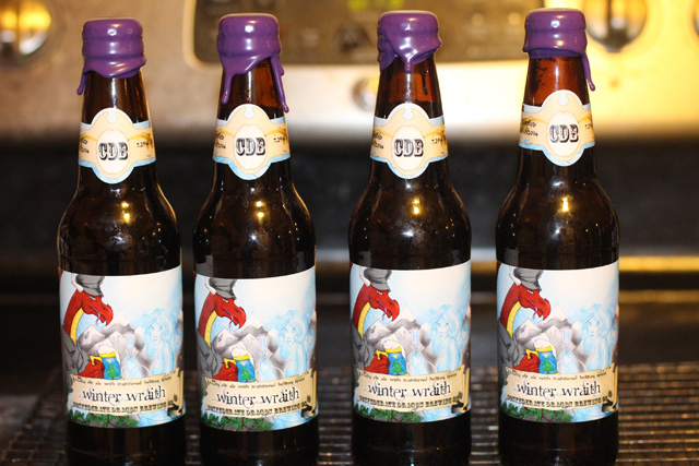 Holiday beer bottles, labeled and waxed